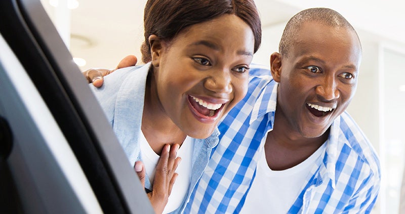 new car couple smiling