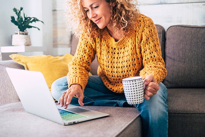 woman on laptop sitting on couch